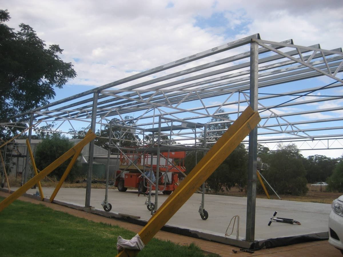 Metal Frame of a Building Under Construction on a Concrete Pad — Daniher Building Company in Flynn, ACT