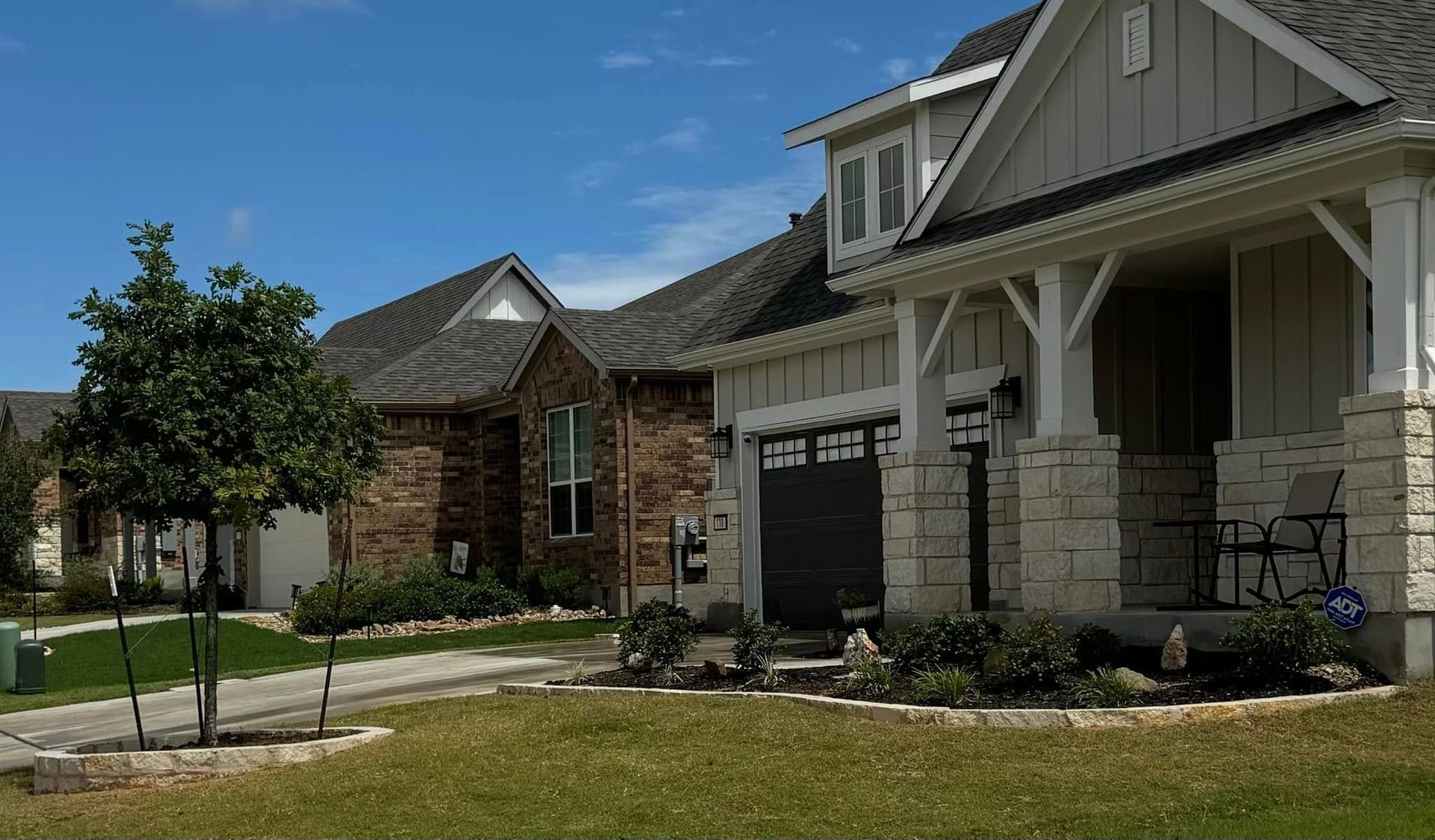 Houses with varying architectural styles on a sunny day.