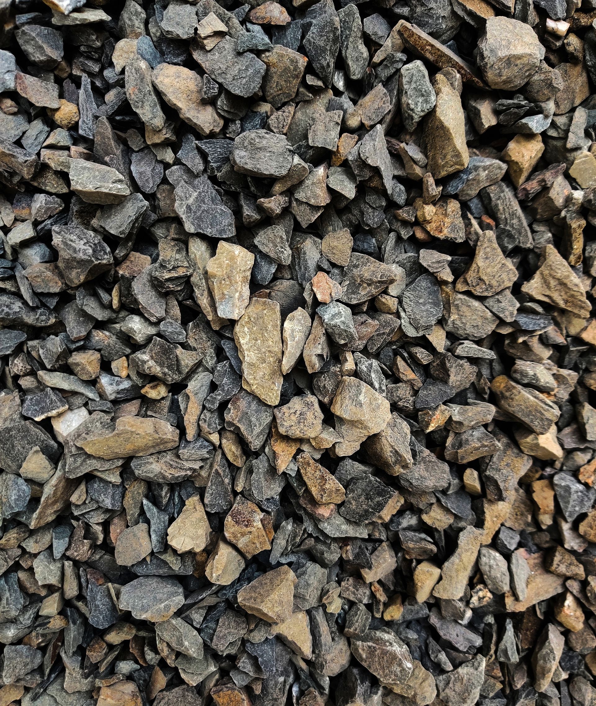 A pile of gravel is sitting on the ground.