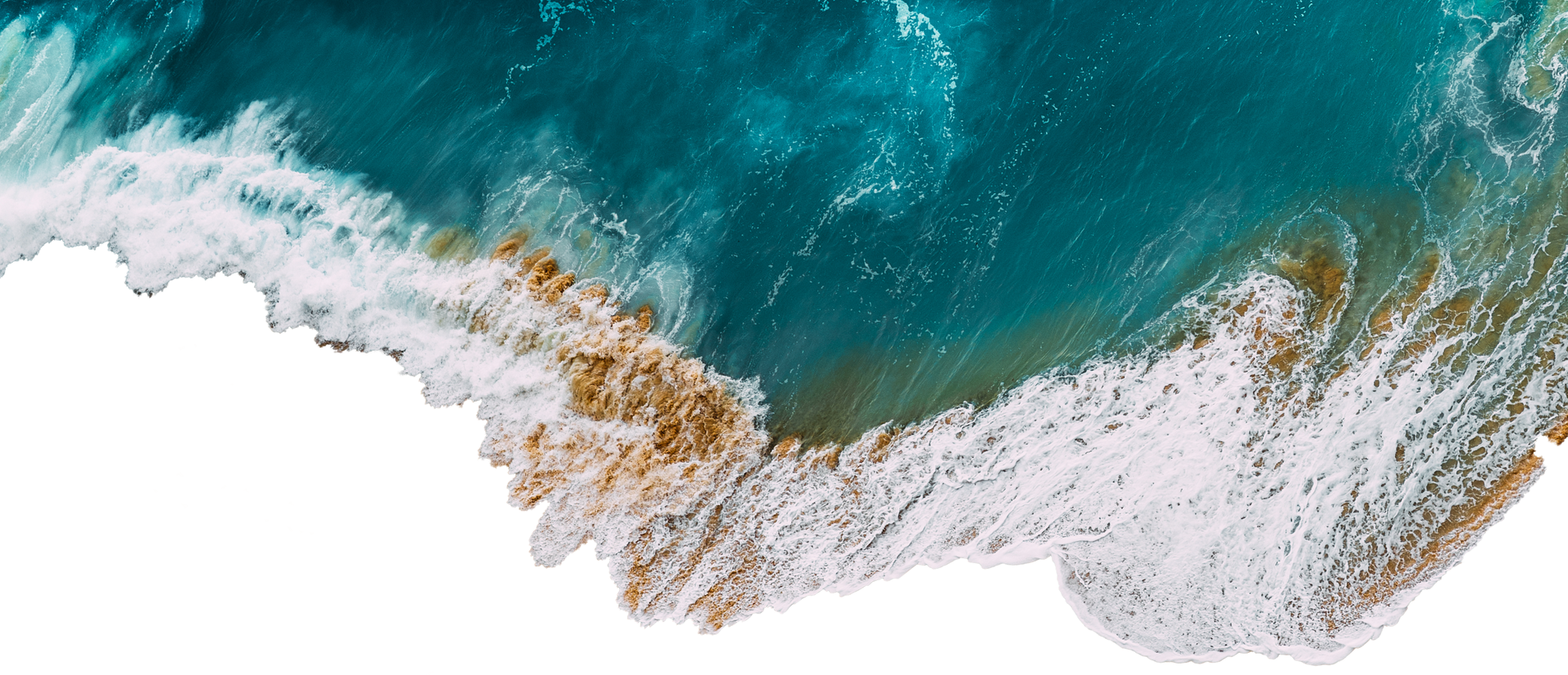 Aerial view of turquoise ocean waves crashing onto a white sandy shore