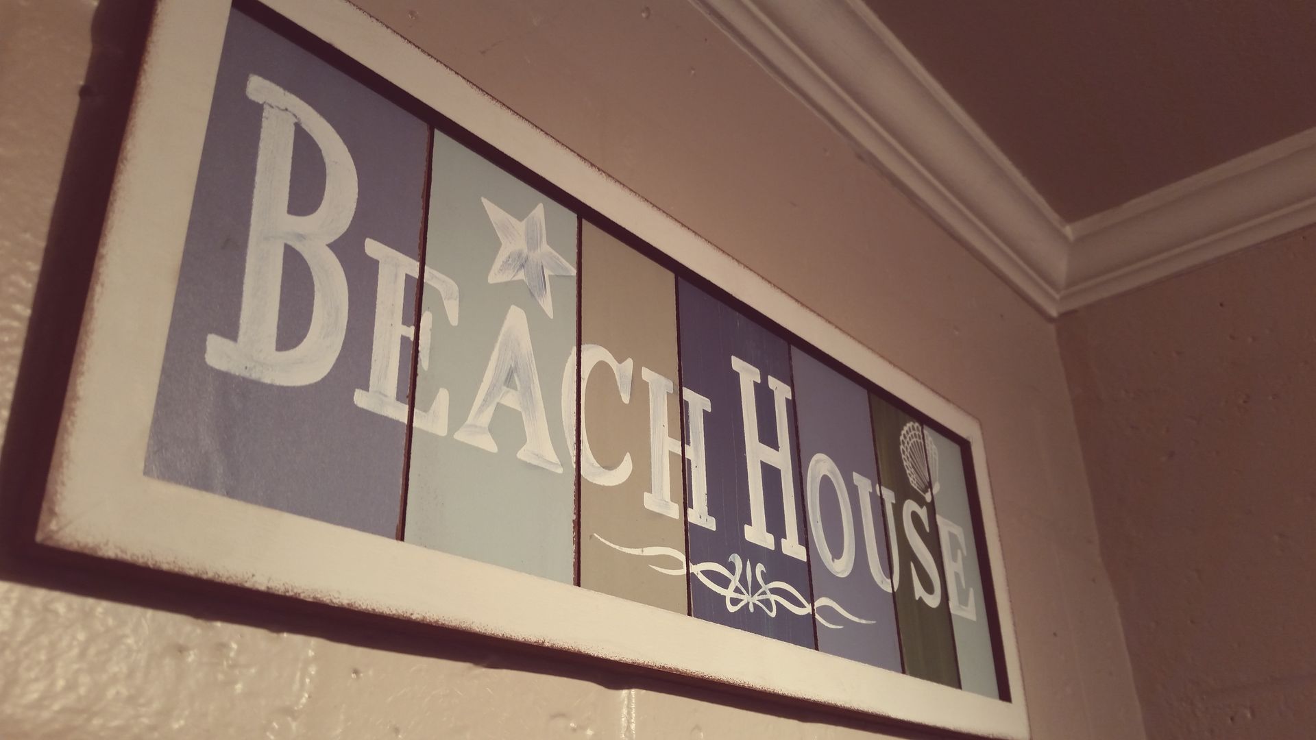 Black House sign on a wall, with large white letters on dark panels.