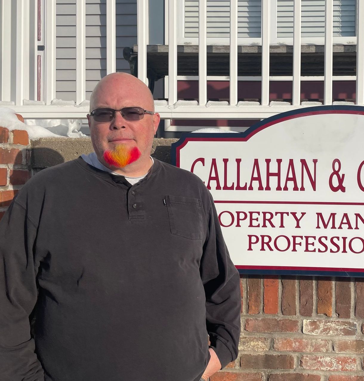 A man standing in front of a callahan & company sign