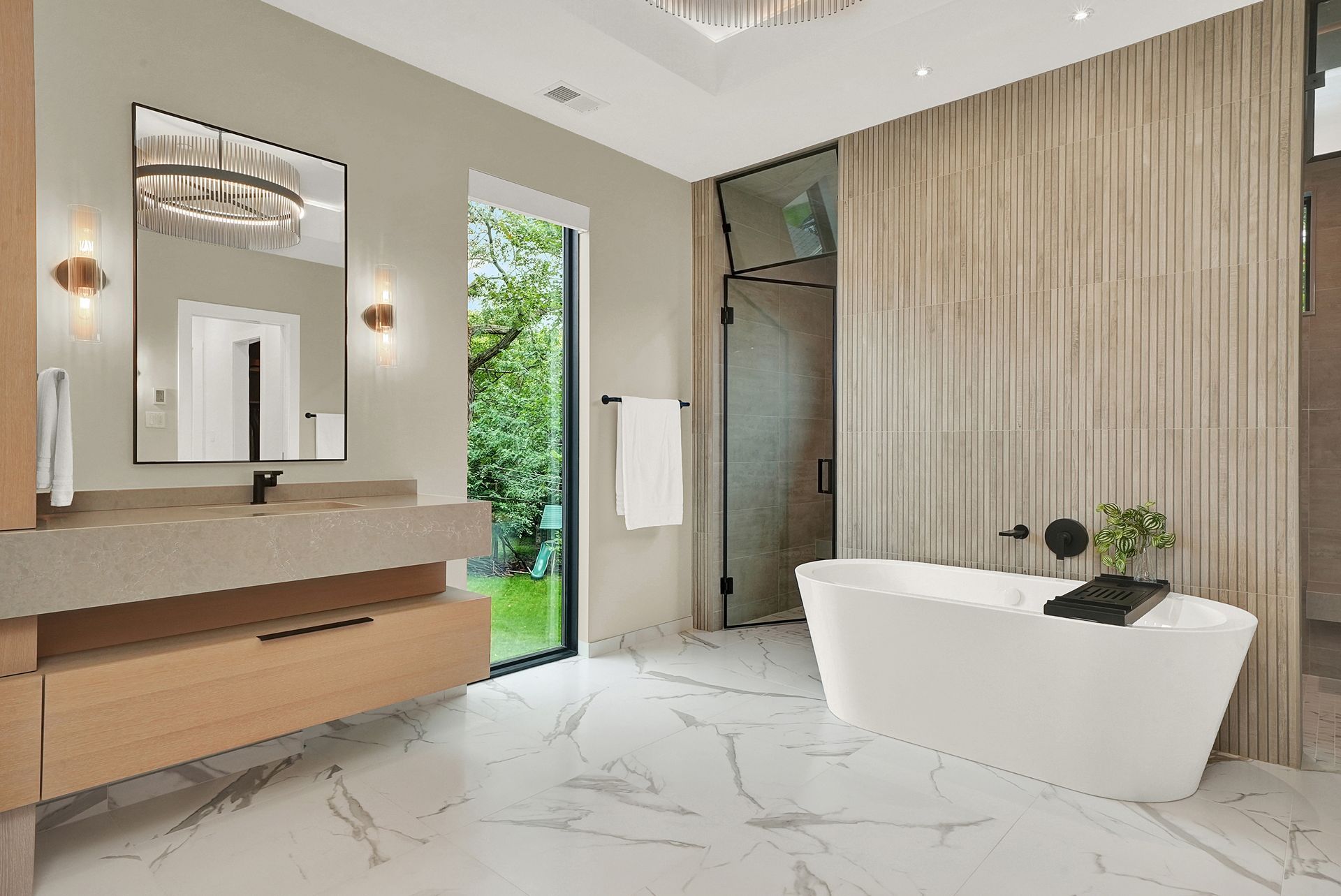 Modern luxury bathroom with marble floor, wooden wall paneling, floating vanity, and freestanding tub by a glass door
