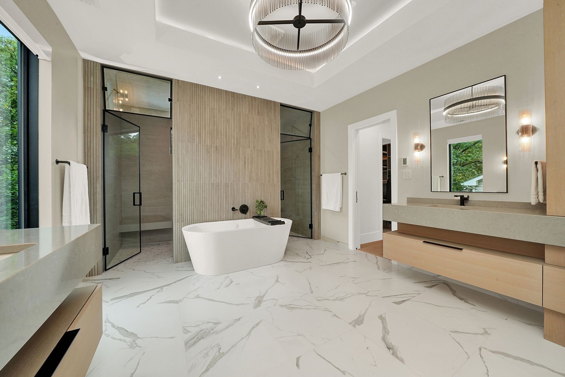 Modern bathroom with freestanding tub, double vanity, large mirror, and marble floors, in a bright neutral design