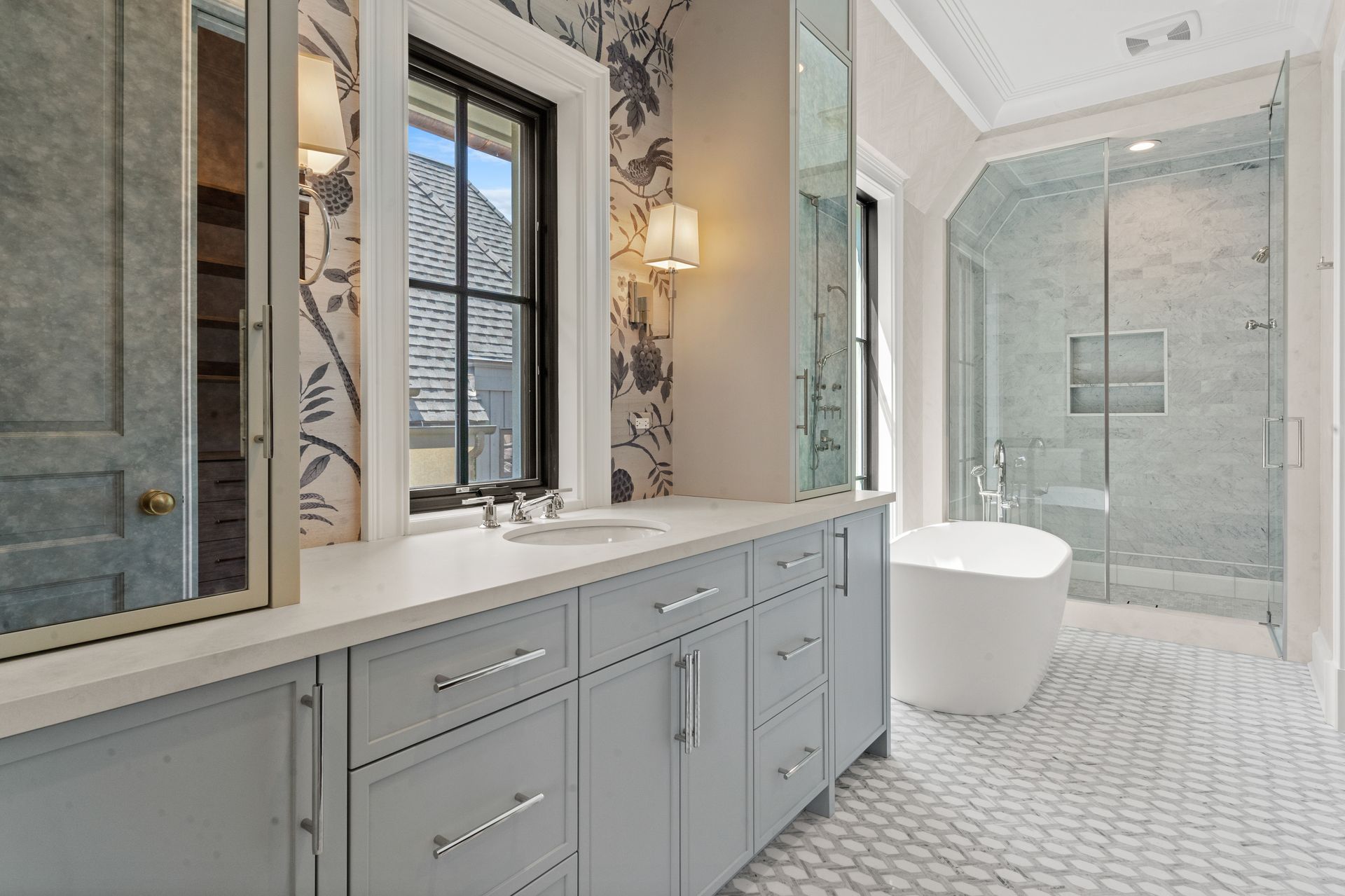 Bright modern bathroom with double vanity, large mirror, and glass shower