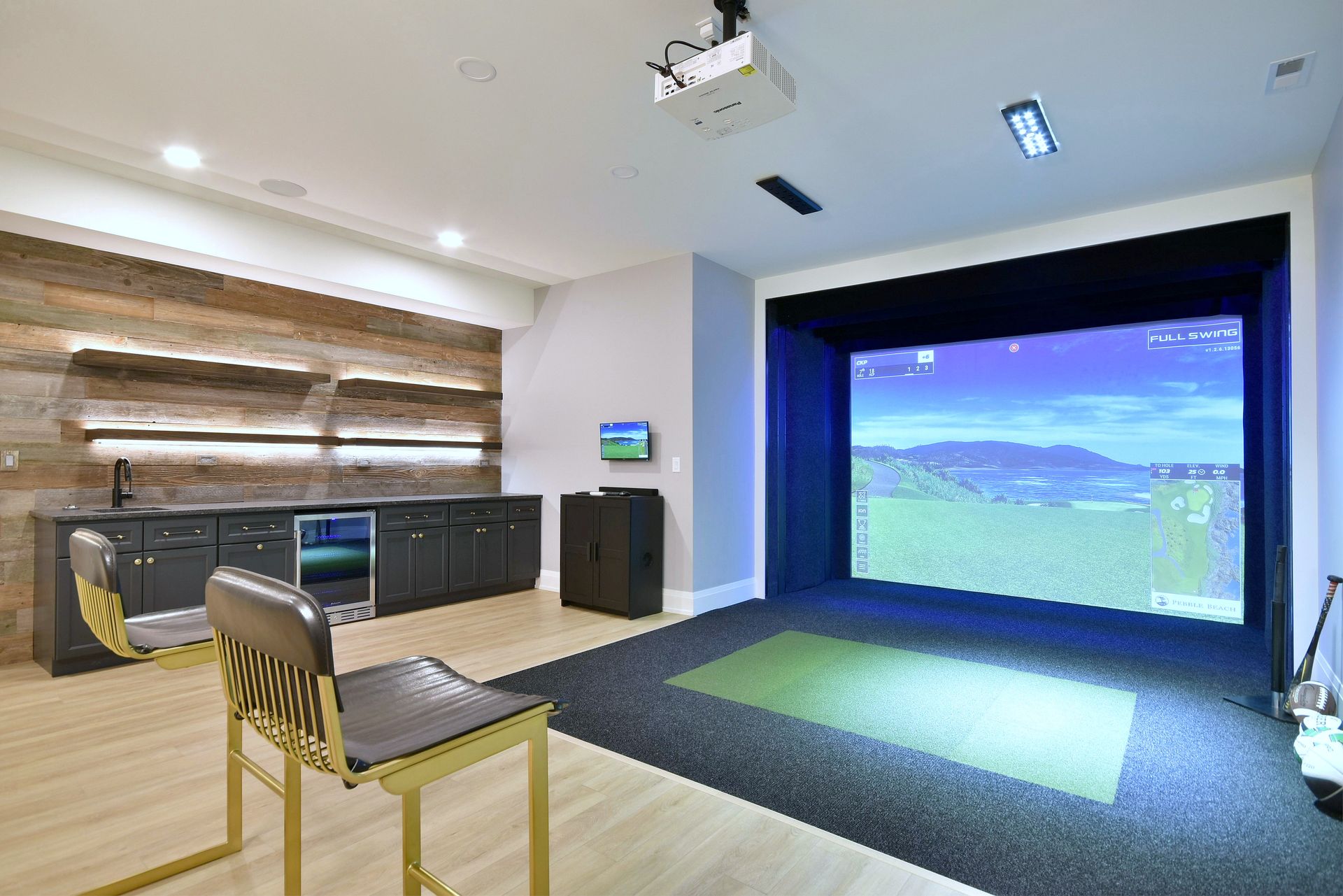 Modern media room with projector screen, seating, and a large virtual golf-style display