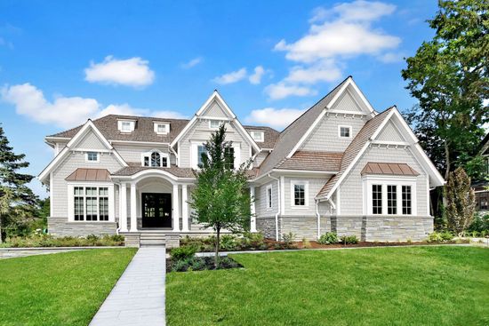 A large house with two garage doors and a porch