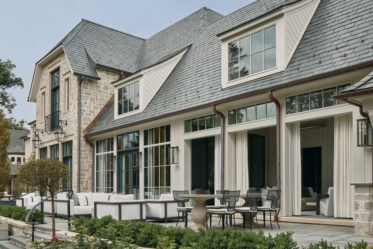 A patio with a fireplace and a couch in the middle
