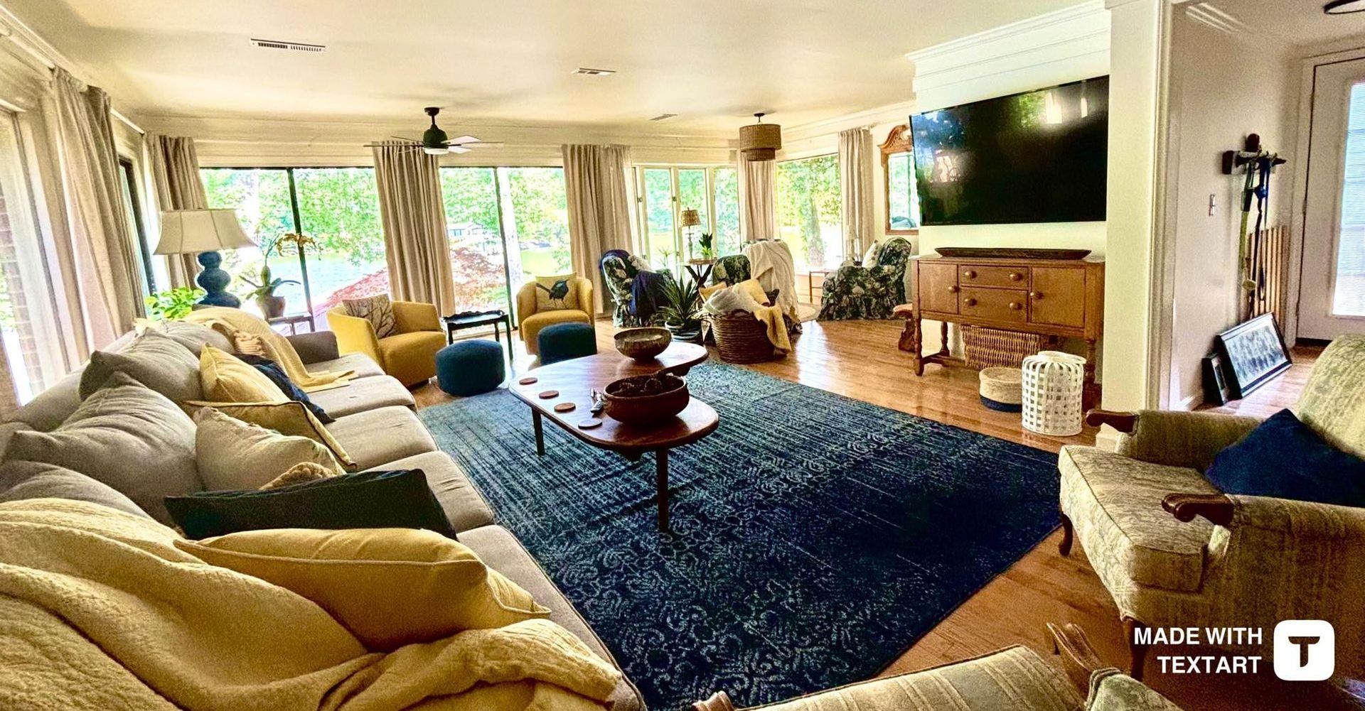 A living room with a lot of furniture and a flat screen tv.