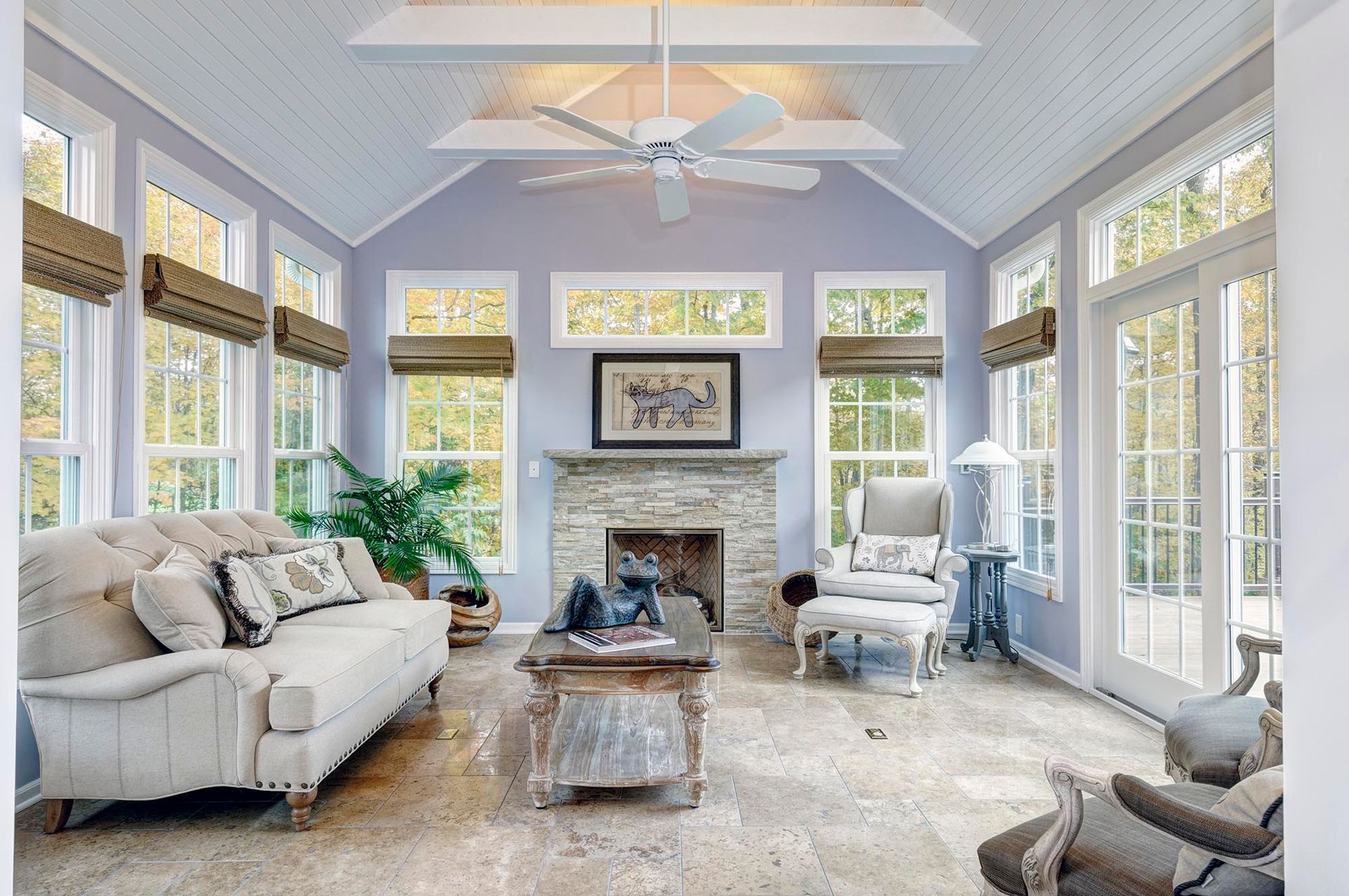 A living room with a ceiling fan and a fireplace