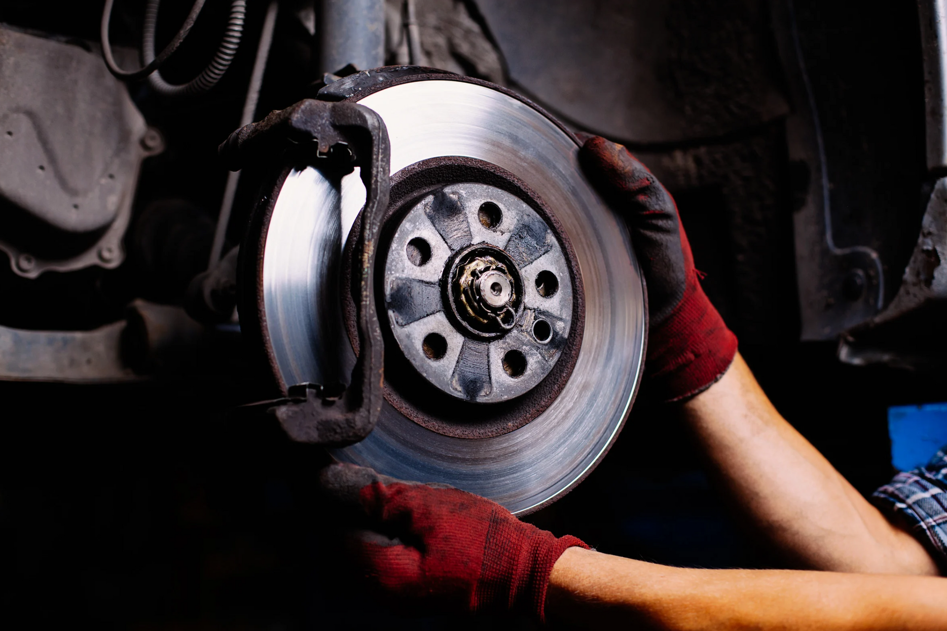 A person is fixing a brake disc on a car.