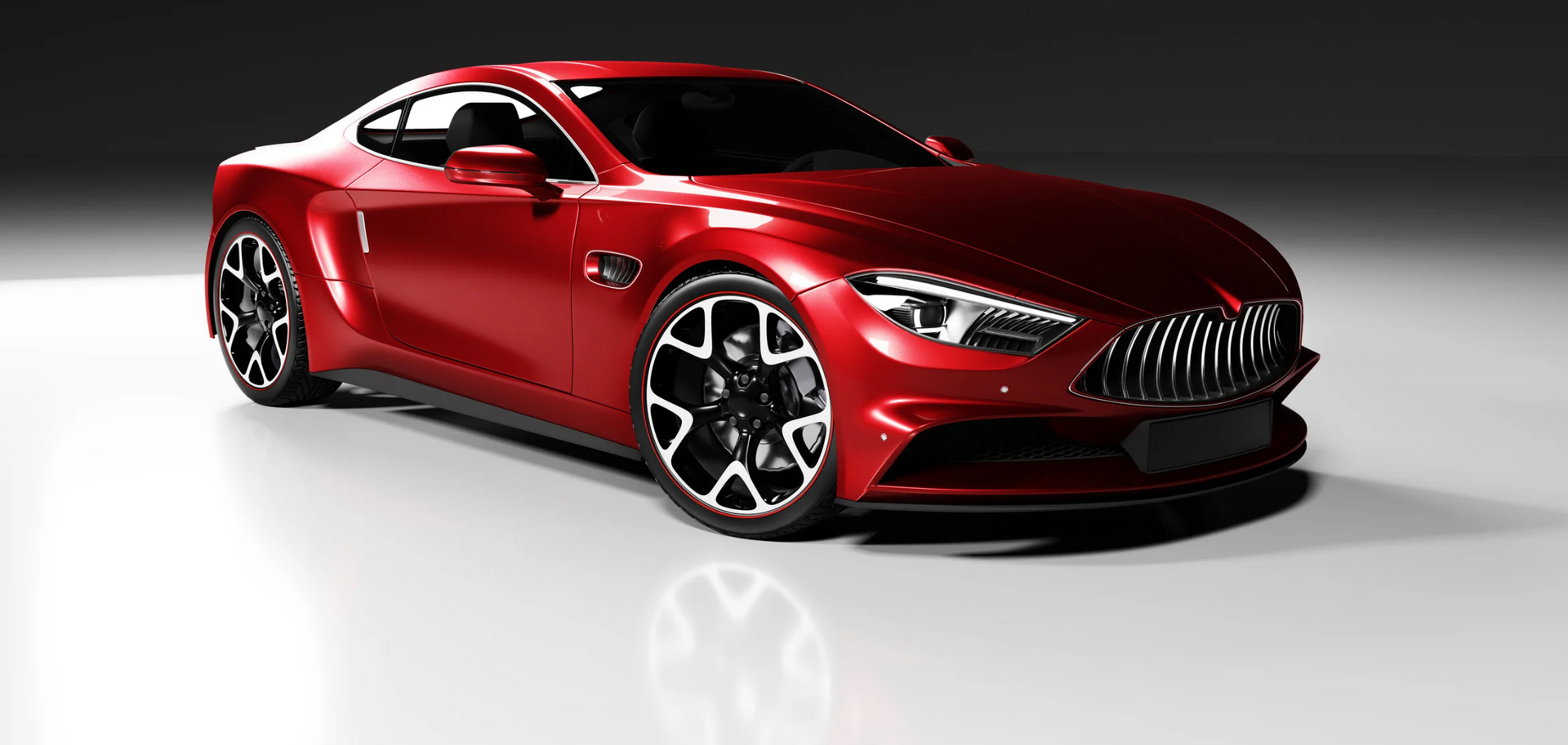 A red sports car is parked on a white surface.