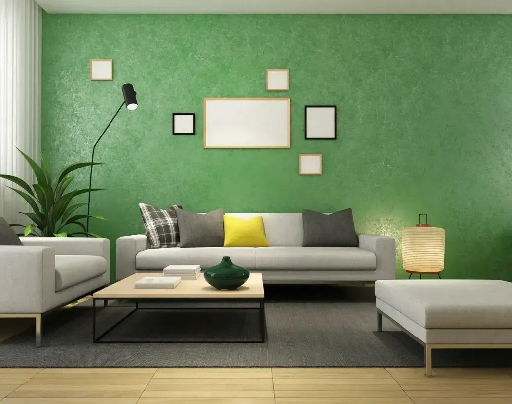 A living room with green walls and white furniture.