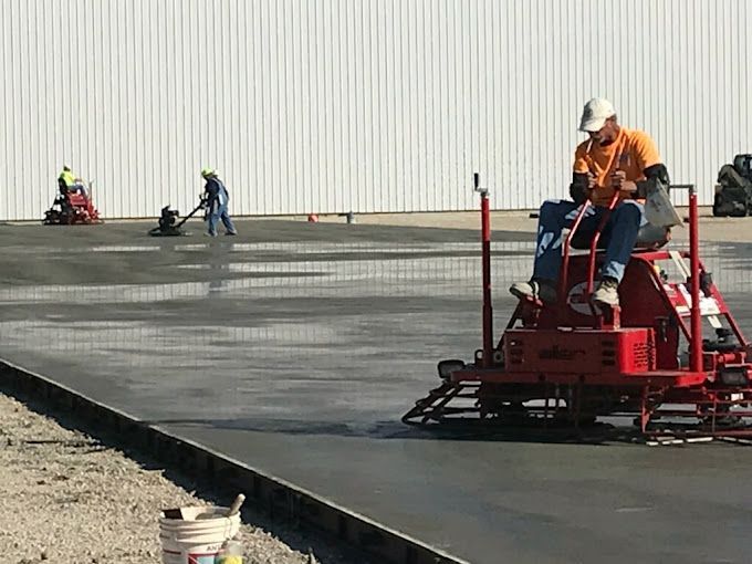 A man is riding a machine on a concrete surface