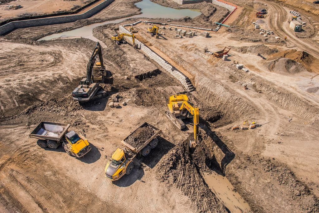 An aerial view of a construction site with trucks and machinery.