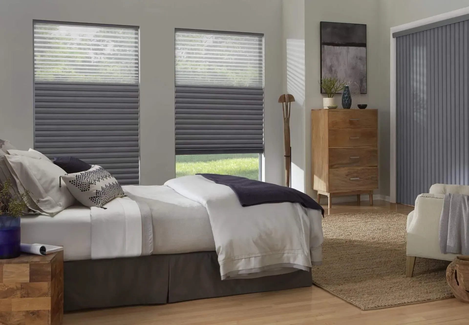 a bedroom with a bed , dresser , chair and gray blinds Love is Blinds.