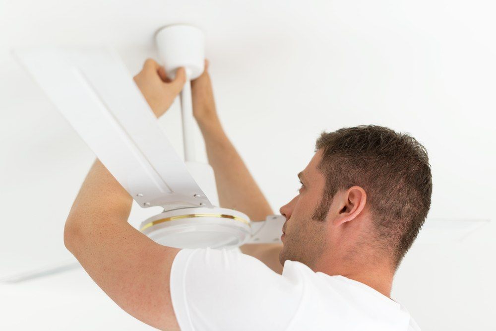 Man Installing A White Ceiling Fan — Aliance Group in Kempsey, NSW