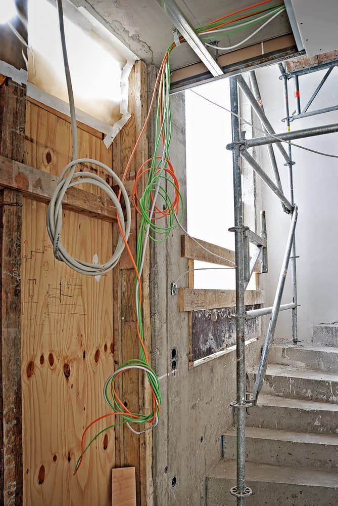A Wooden Wall With a Bunch of Wires Hanging From It — Aliance Group in Grafton, NSW