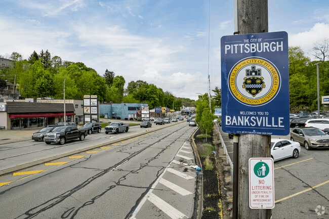 A blue sign on a pole says pittsburgh banksville.