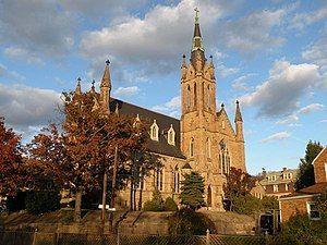 A large church with a steeple and a cross on top of it