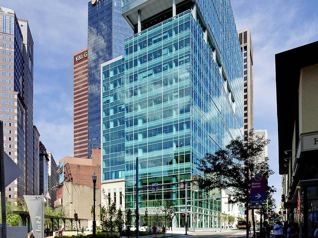 A tall building with a lot of windows in a city