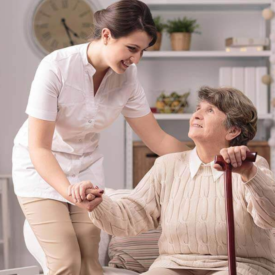 A nurse is helping an elderly woman with a cane.