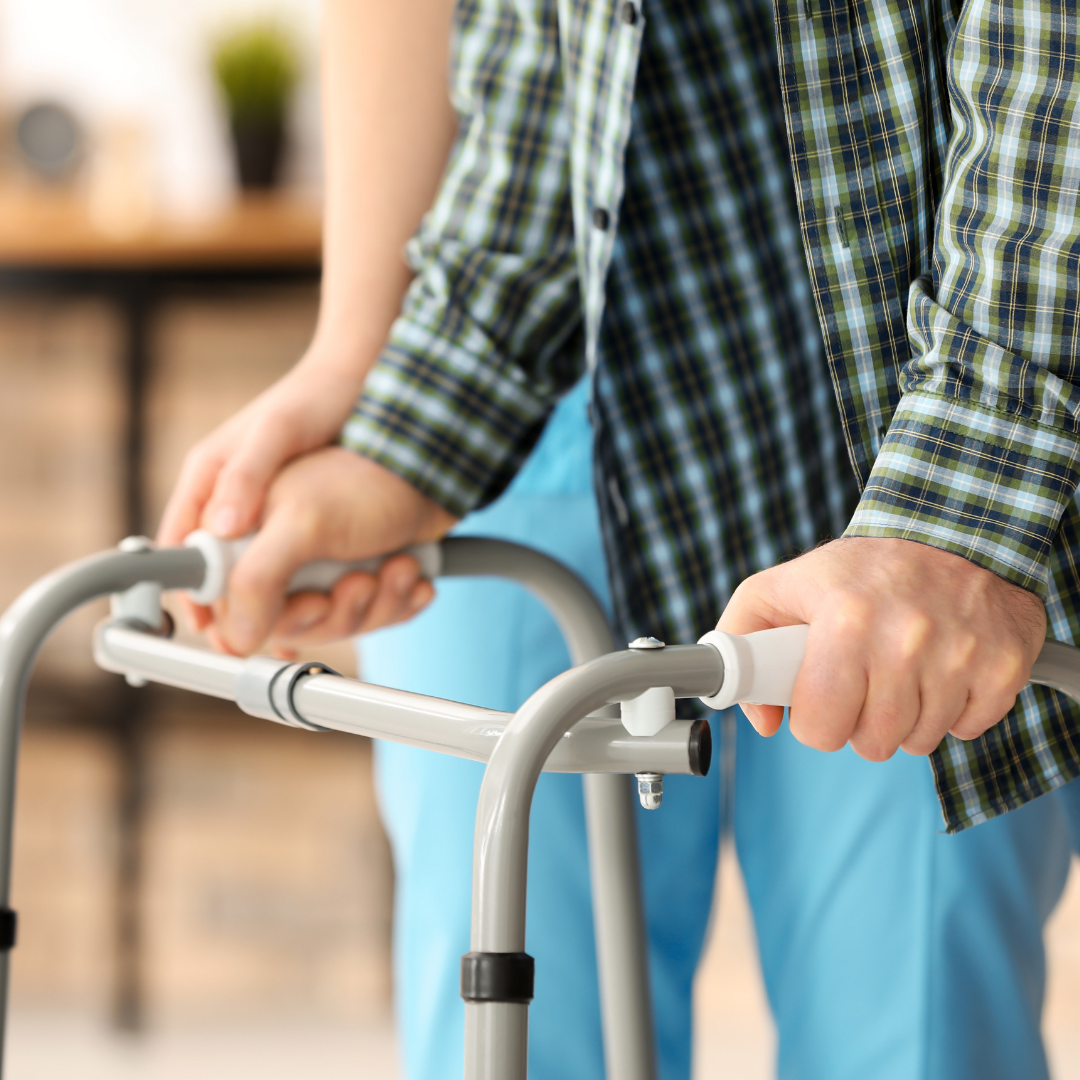A man is using a walker to help him walk.