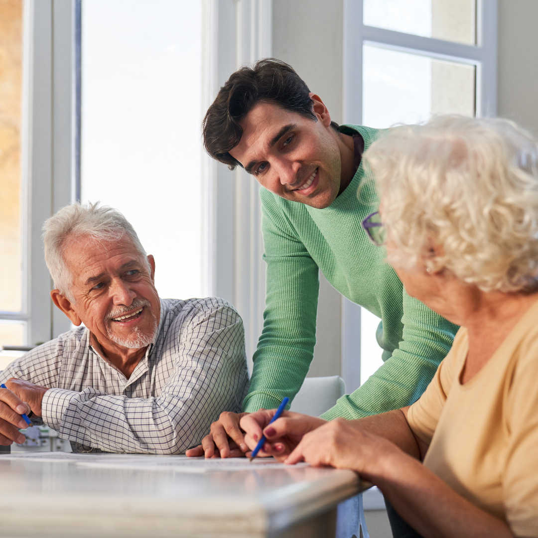 A group of people are sitting at a table talking to each other.
