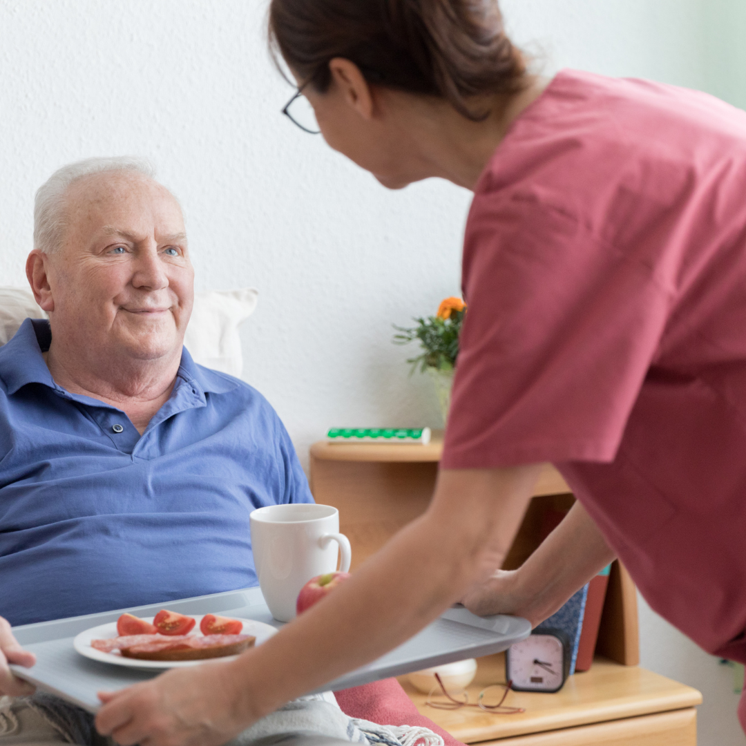 smiling elderly cared for by his caregiver
