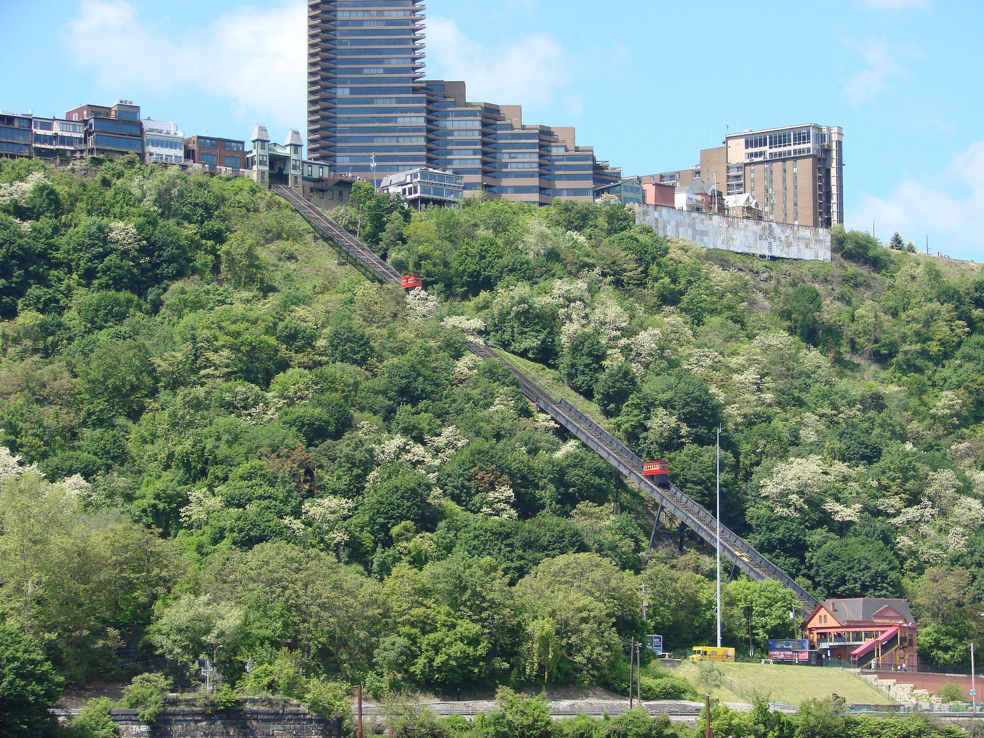 A staircase going up a hill with a city in the background