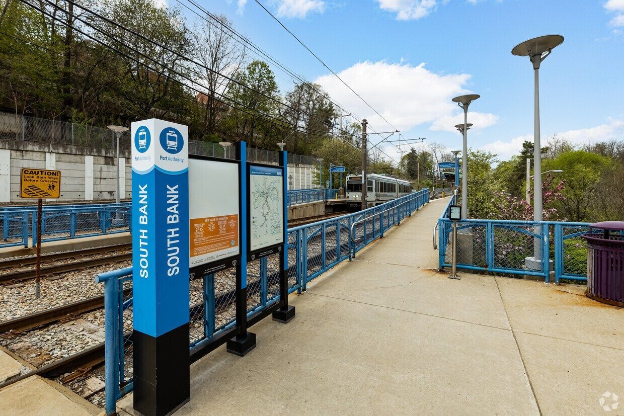 A train station with a blue sign that says south bank