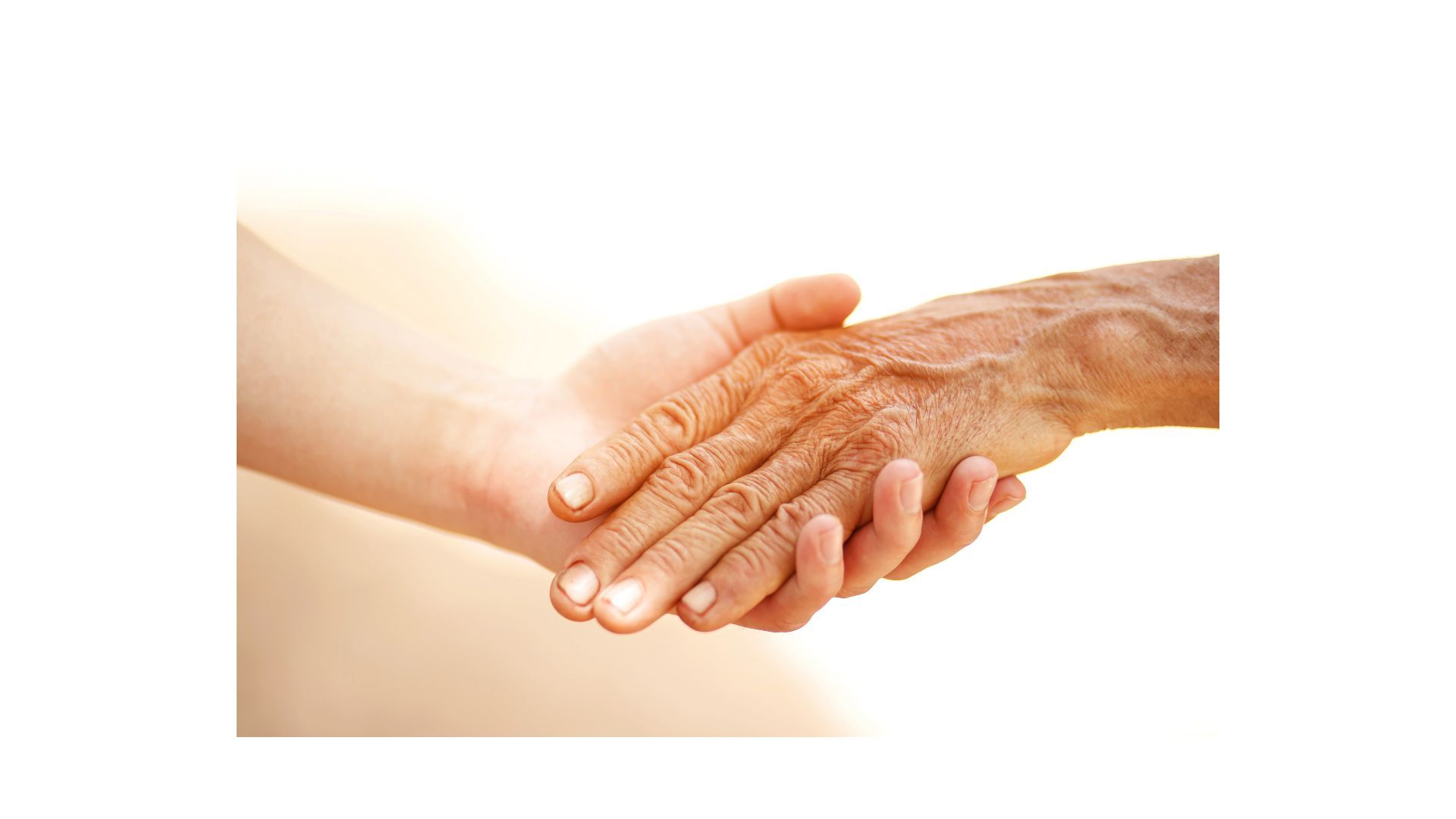 A young woman is holding an older woman 's hand.