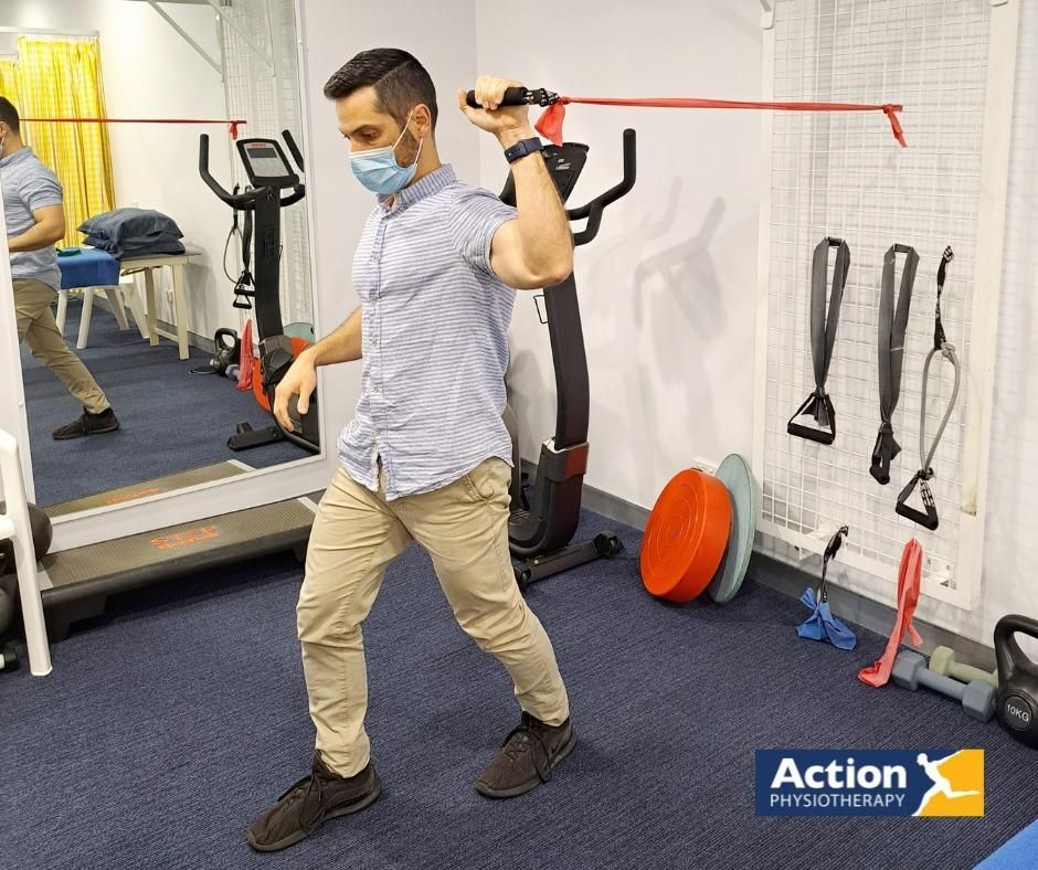 A Man Wearing a Mask Is Doing Exercises in A Gym — Action Physiotherapy in Cooks Hill, NSW