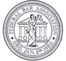 The seal of the federal bar association shows a woman holding scales of justice.