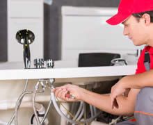 Plumber Working On Sink - Urbana, OH - Houser & Brinnon Plumbing & Heating Plumber Working On Sink - Urbana, OH - Houser & Brinnon Plumbing & Heating