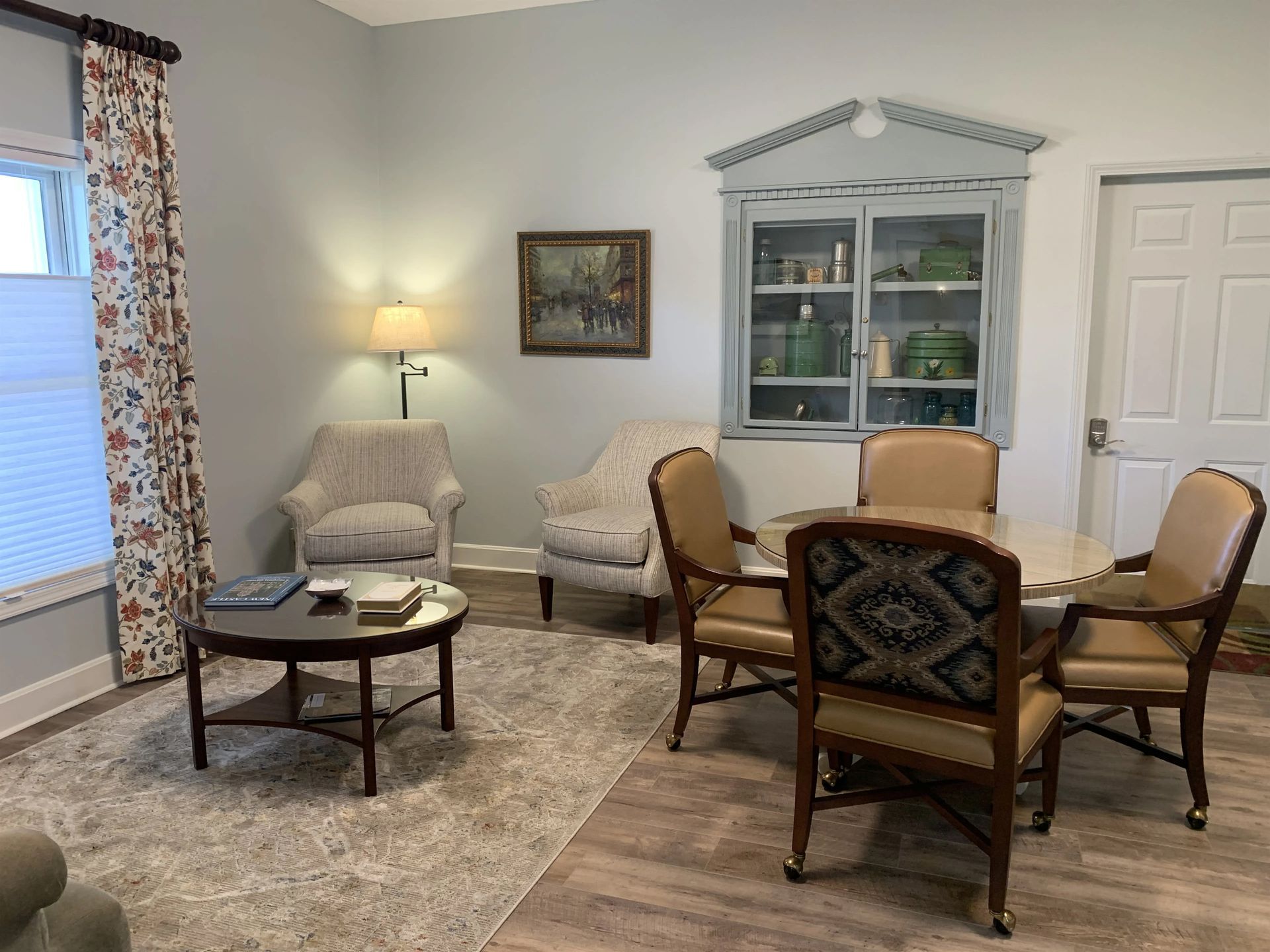 a living room with a table and chairs in it .