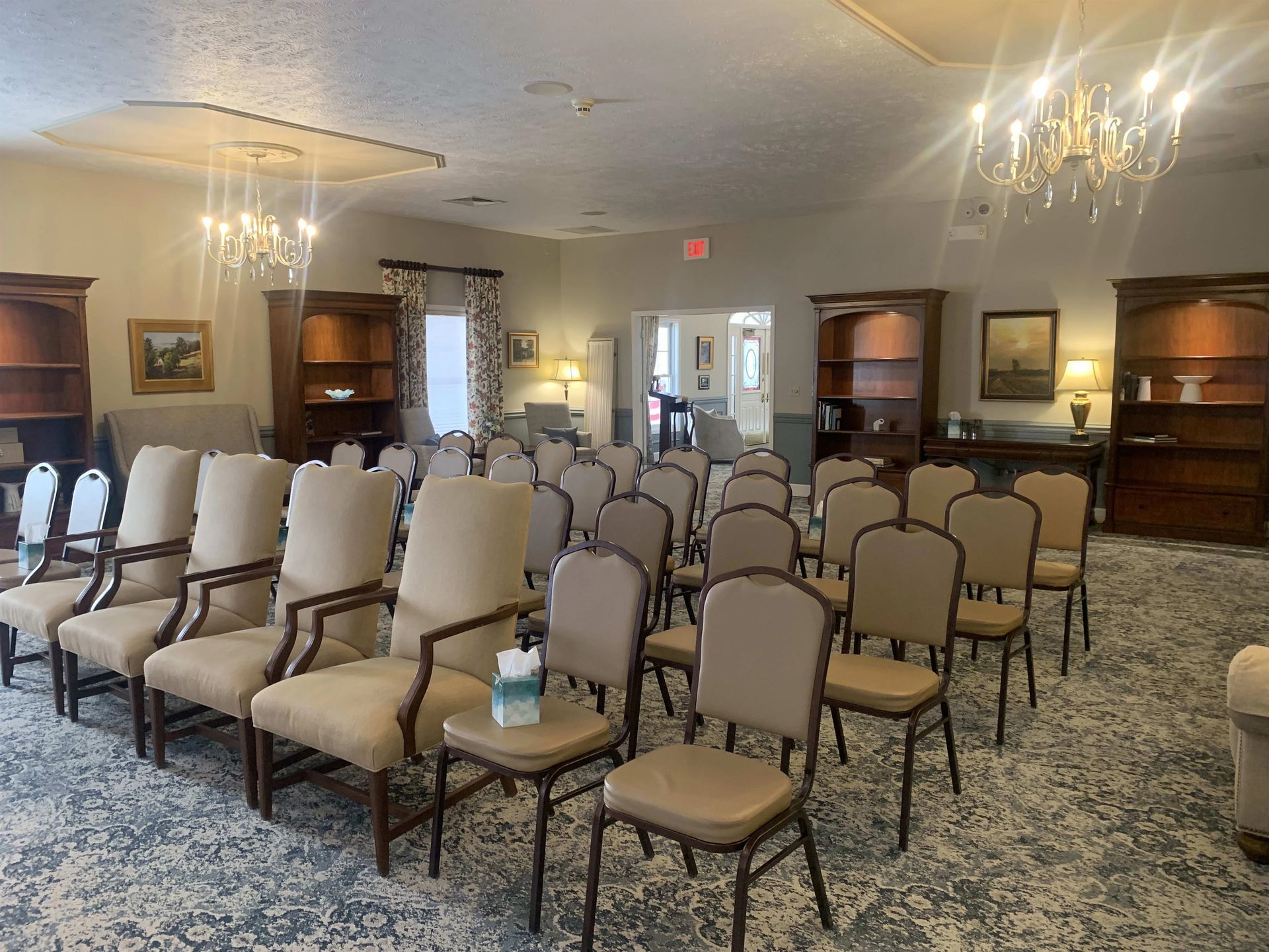 a large room filled with chairs and a chandelier .
