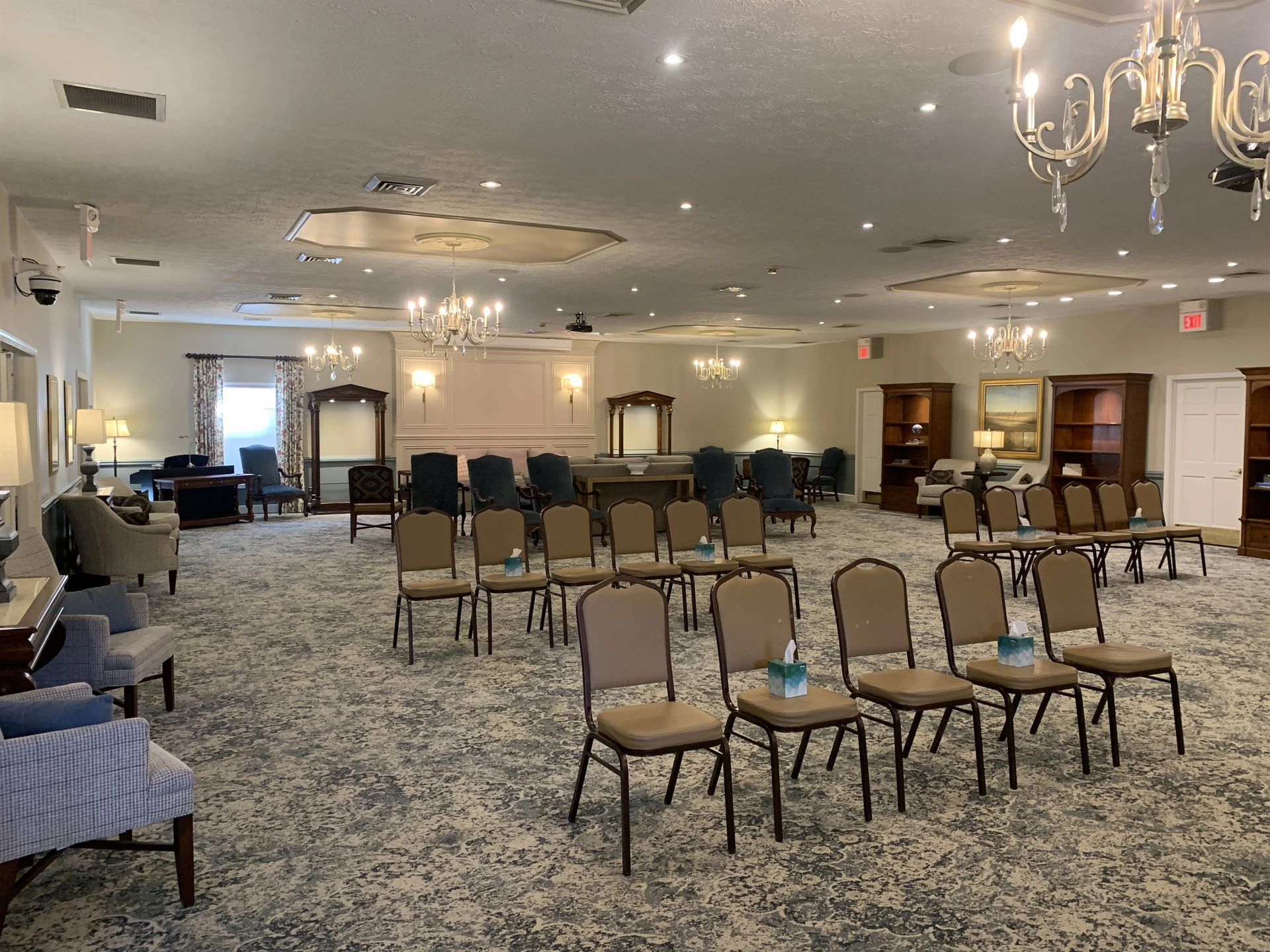 a large room with a lot of chairs and a chandelier .