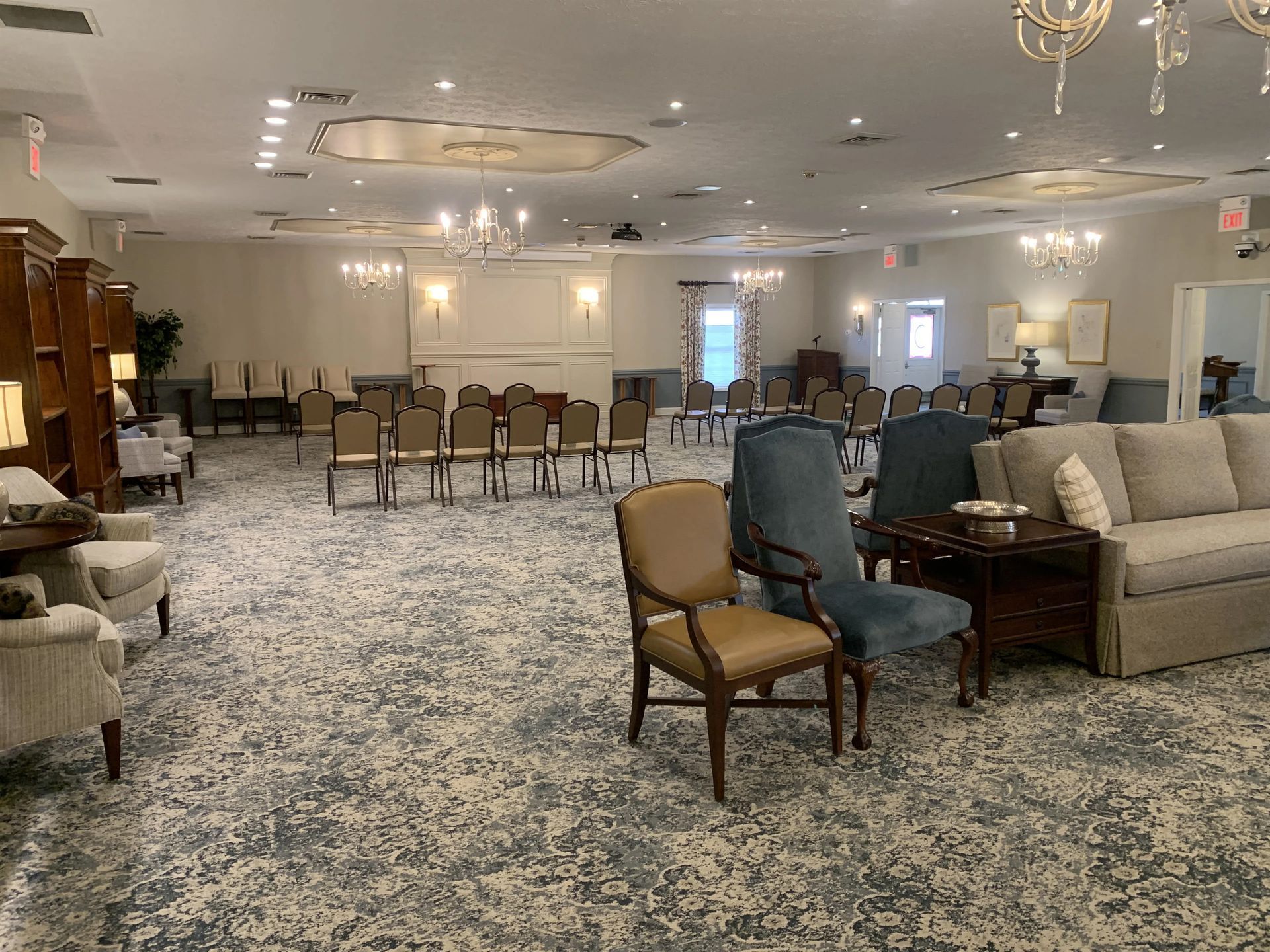 a large room with a couch , chairs , and tables .