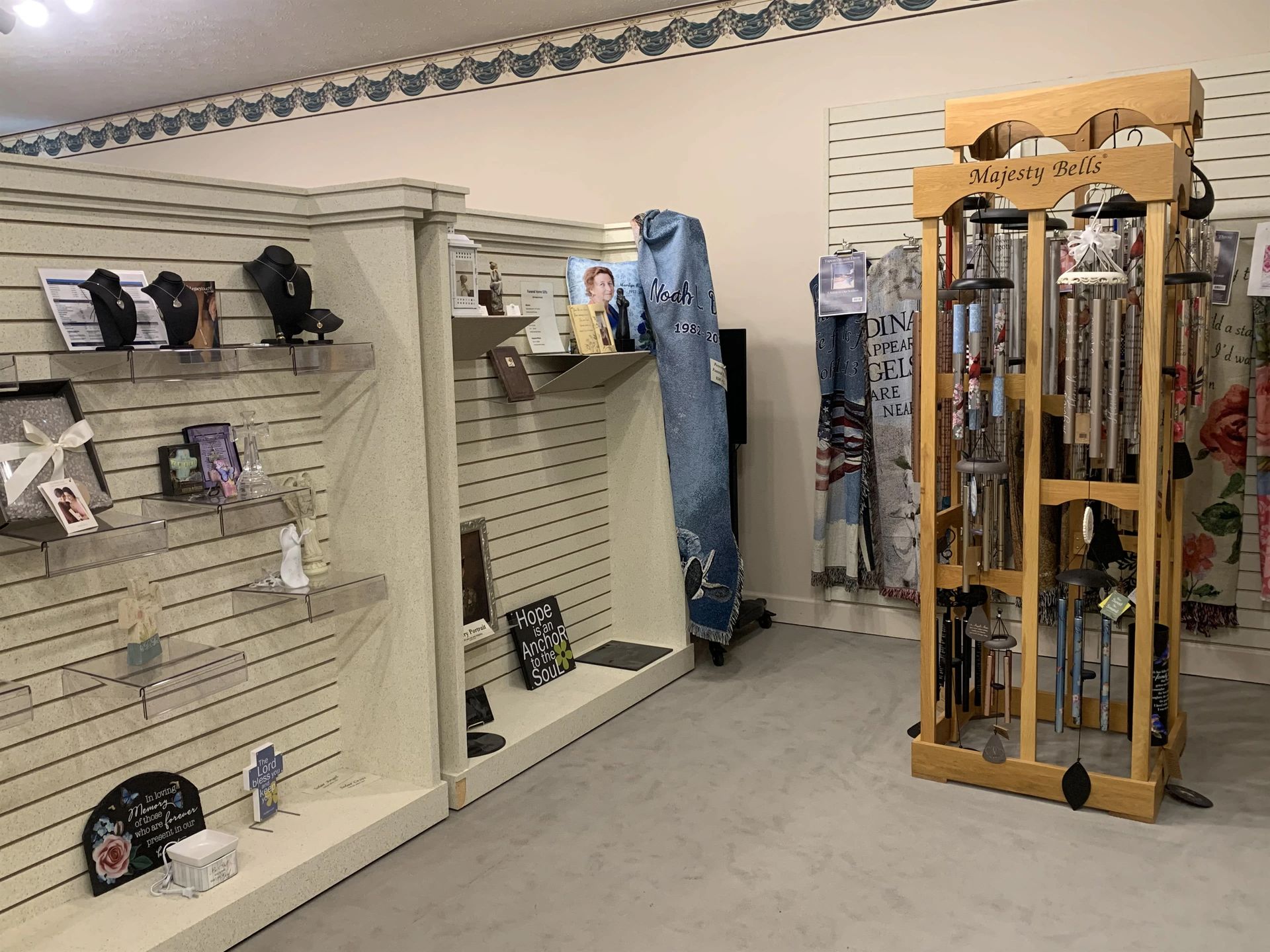 a store filled with lots of items including wind chimes and necklaces .