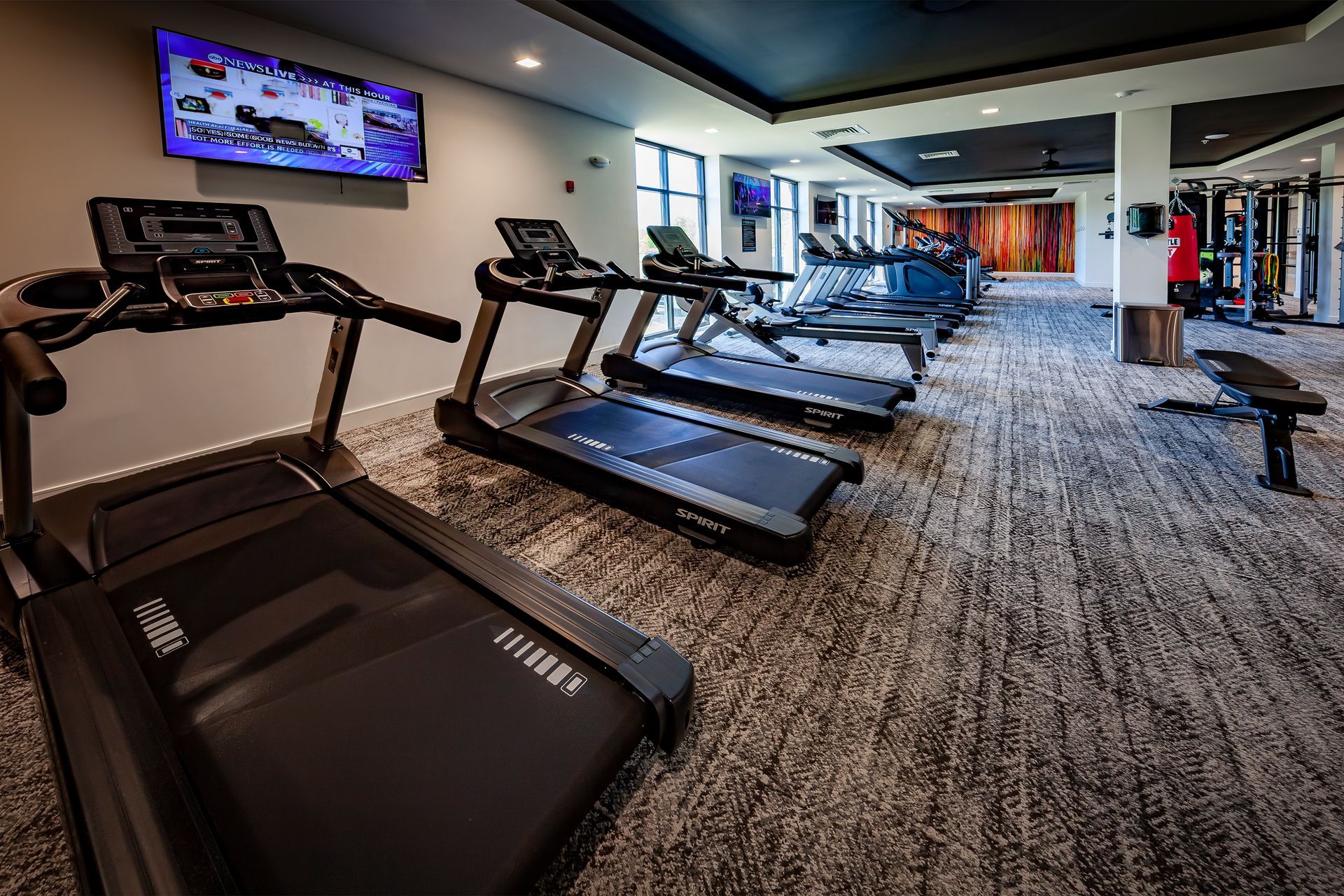 Gym with treadmills, exercise equipment, and a TV at River Place Flats in Fishers, IN.