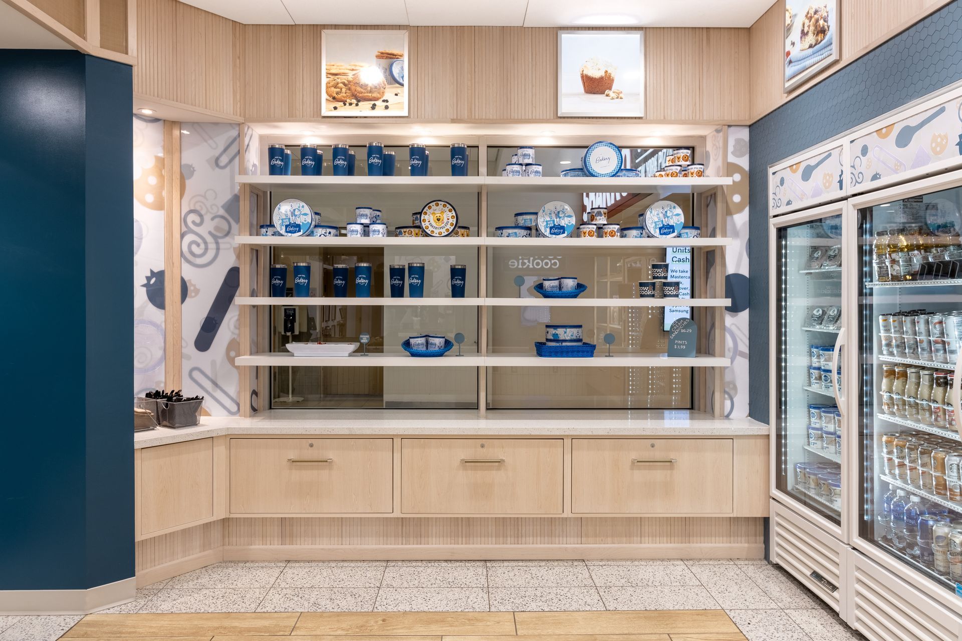Penn State Cow & Cookie's display with built-in shelves, wood cabinets, and a glass-front refrigerator on the right