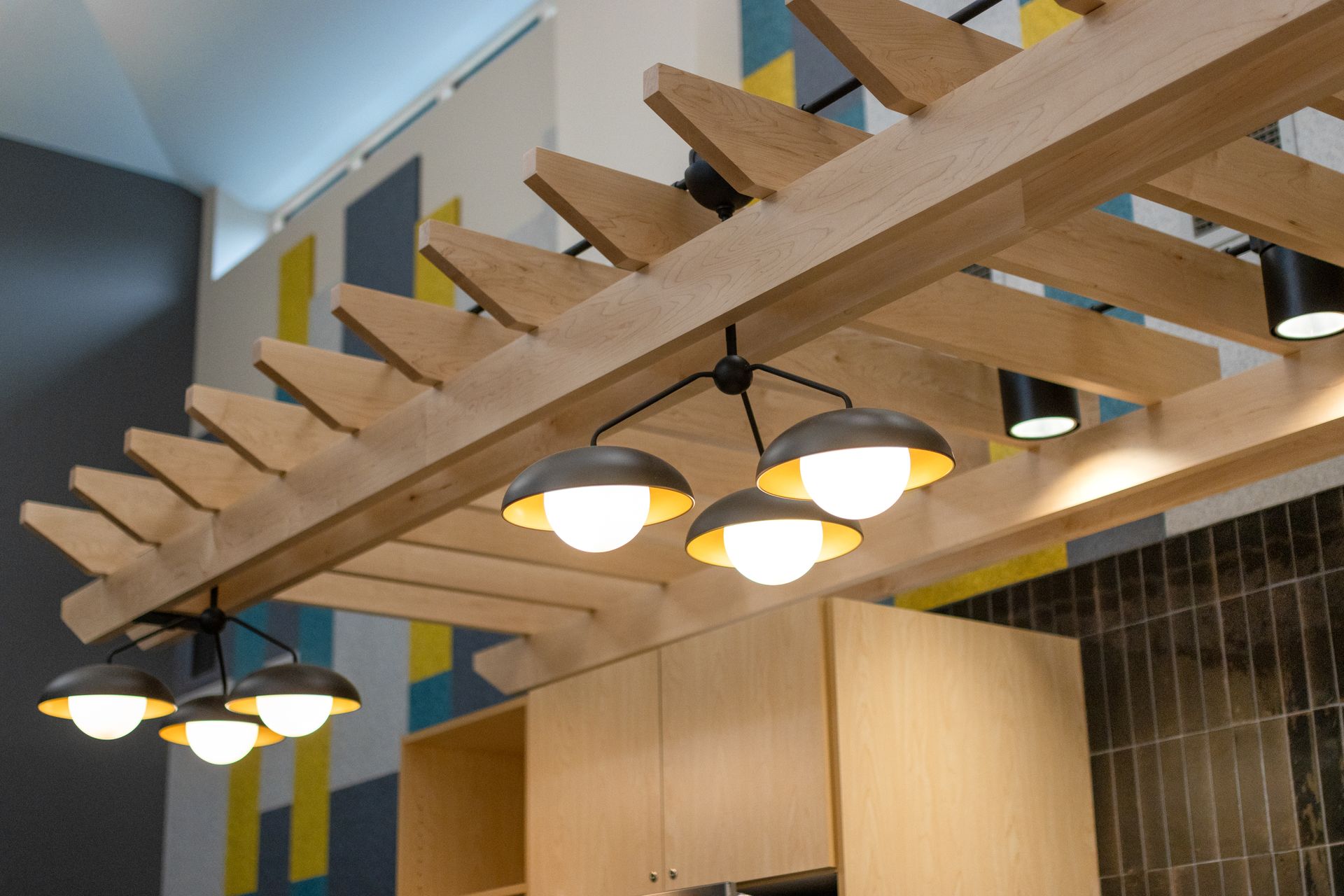 Eastview Terrace Kitchen's wooden beams and pendant lights in a modern interior ceiling detail