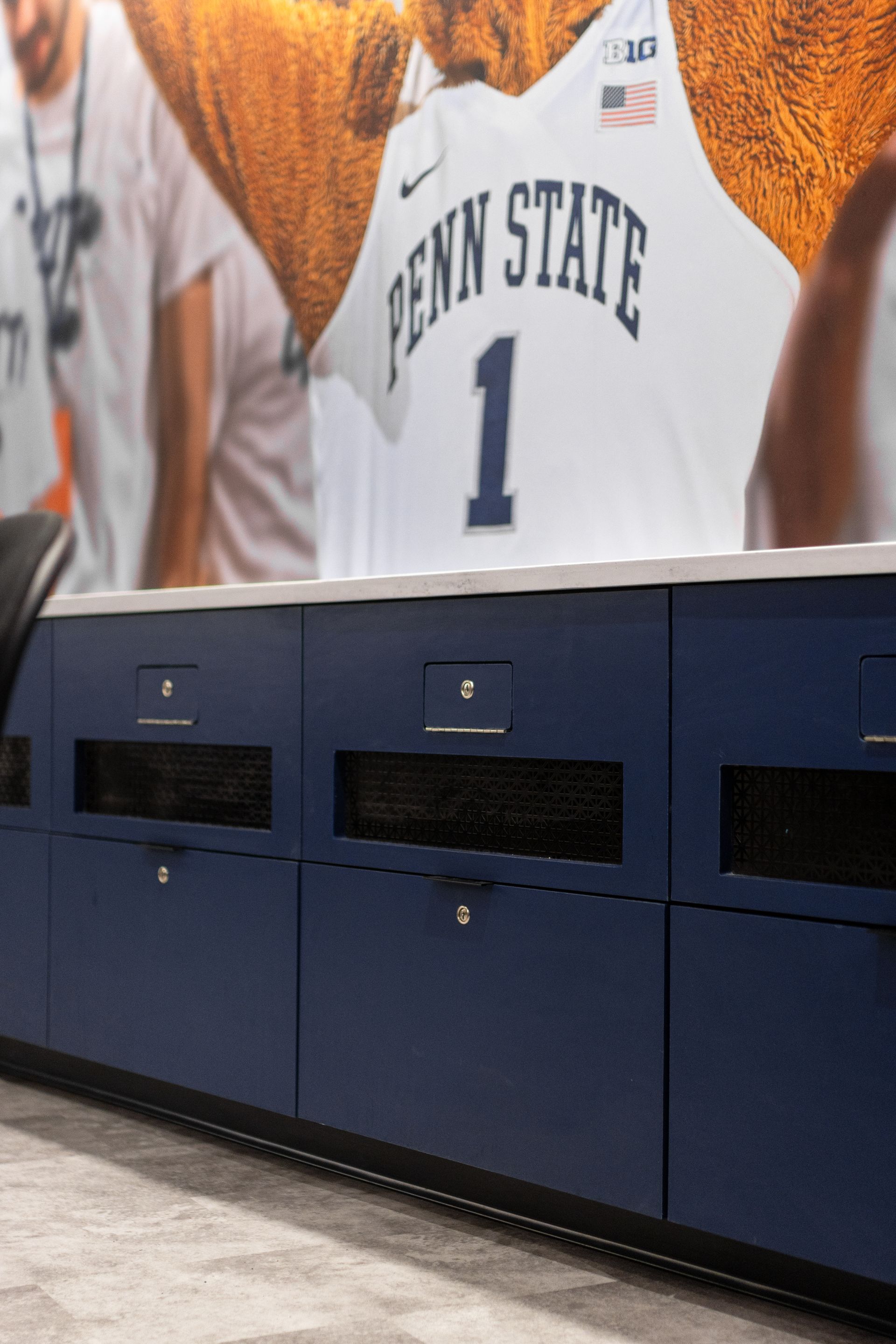 Bryce Jordan Center's Penn State basketball jersey mural above blue locker cabinets