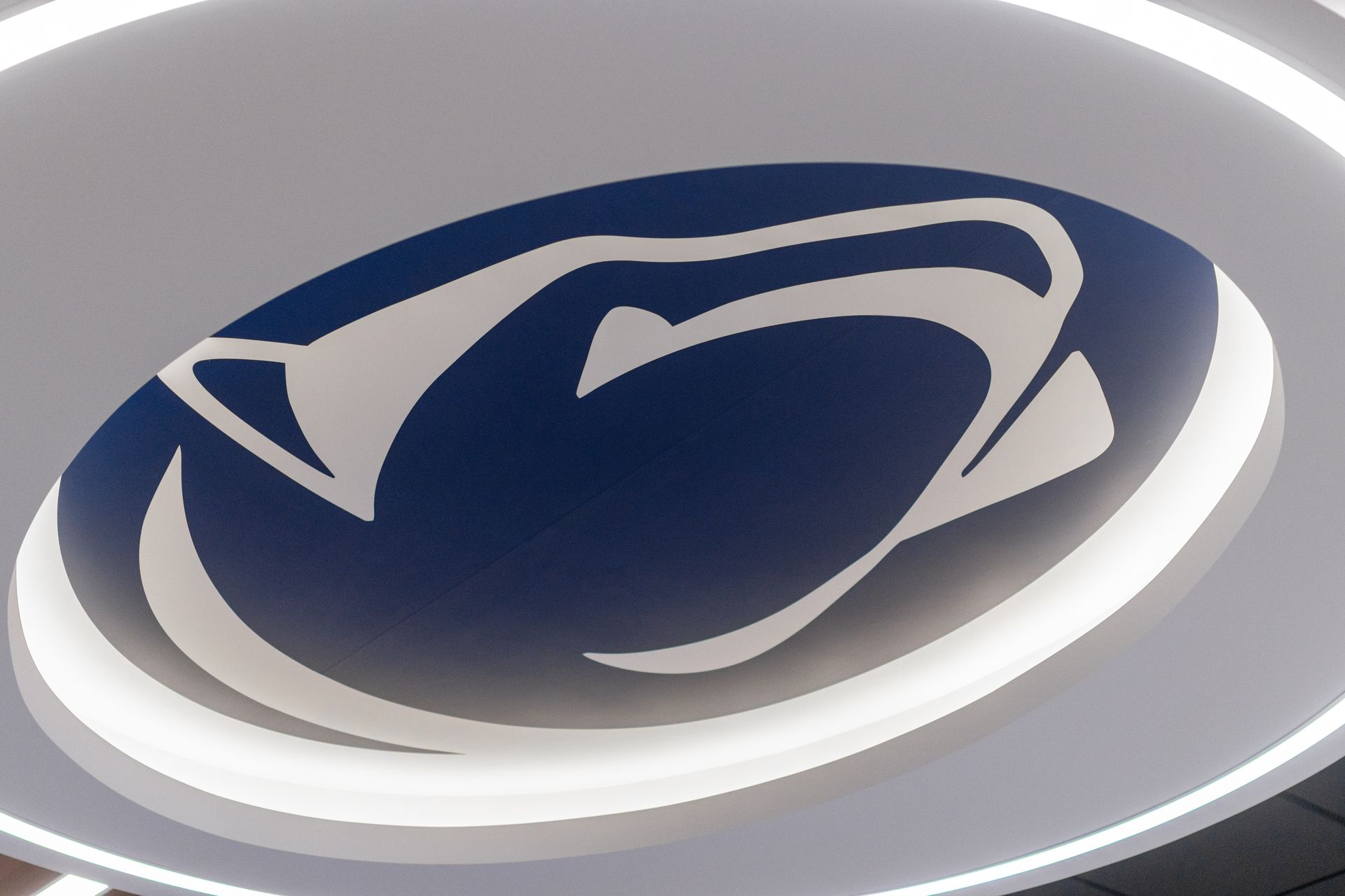 Bryce Jordan Center's stylized navy and white circular logo on a light background