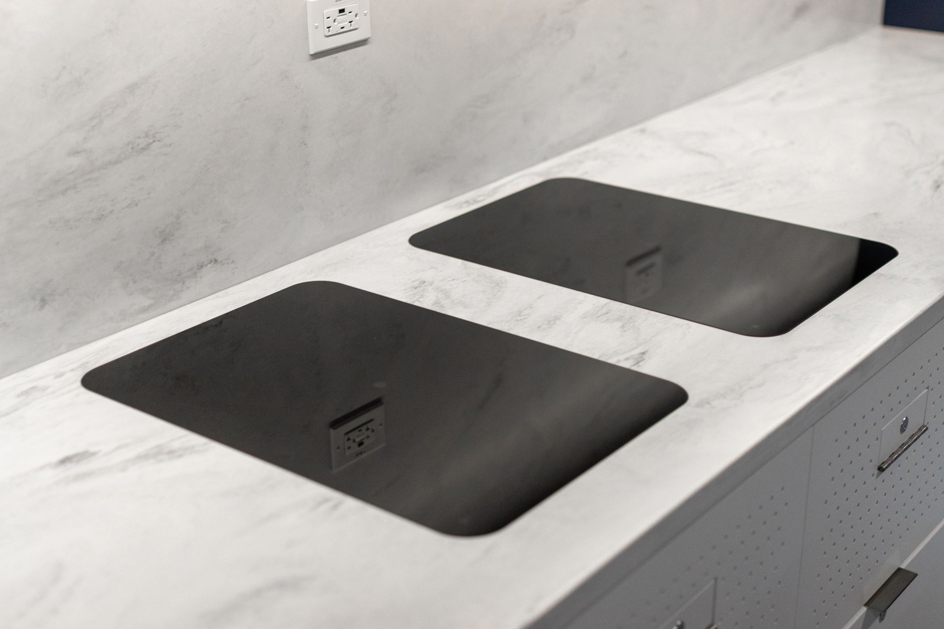 Bryce Jordan Center's two black induction cooktops set into a white kitchen countertop