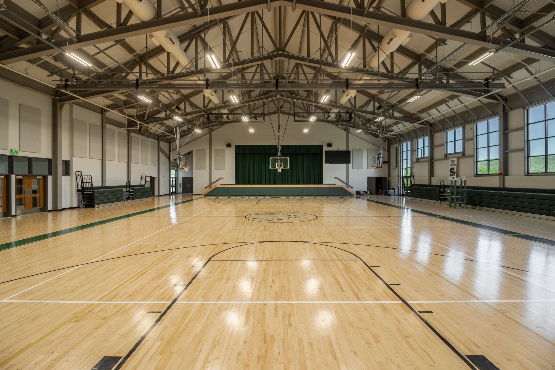 SVRCS Gymnasium basketball court with polished wooden floor and high industrial ceiling