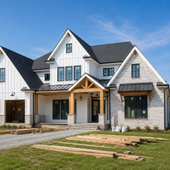 Modern white-and-gray farmhouse-style house with a front porch and unfinished lawn construction