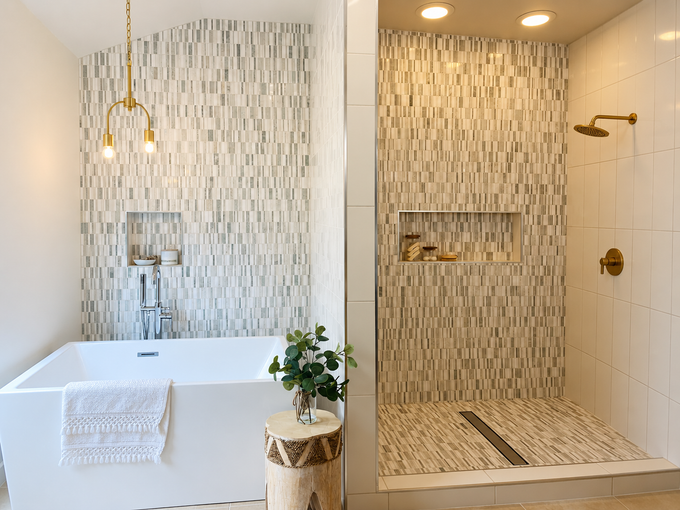 Bright modern bathroom with soaking tub and tiled walk-in shower, lit by recessed ceiling lights.