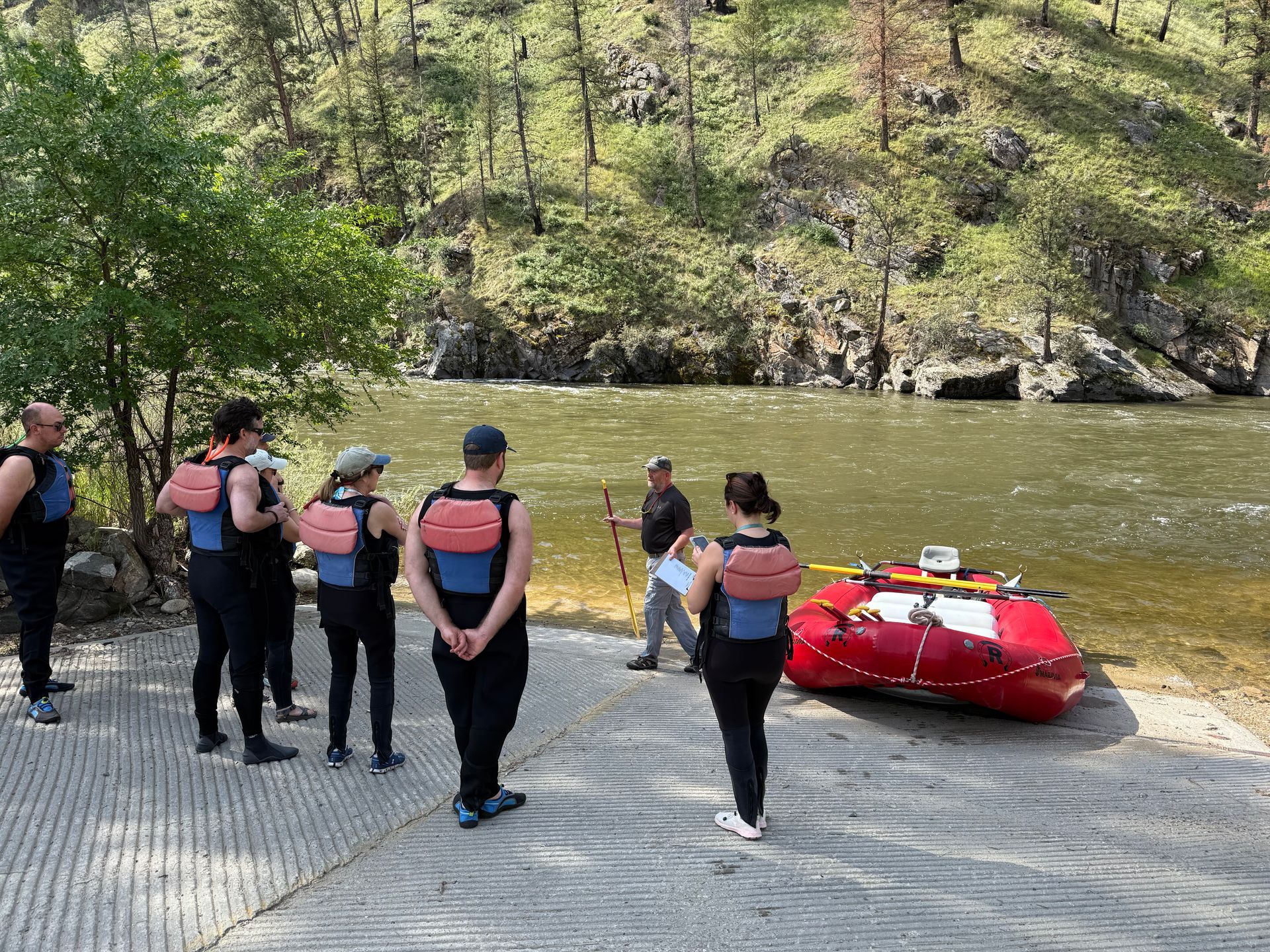 A group of rafters in high-quality gear enjoying a Salmon River rafting trip in Idaho.